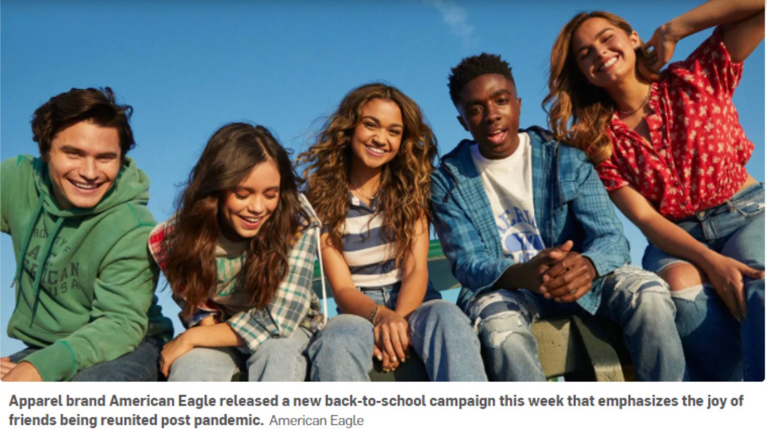 5 teens sitting and smiling