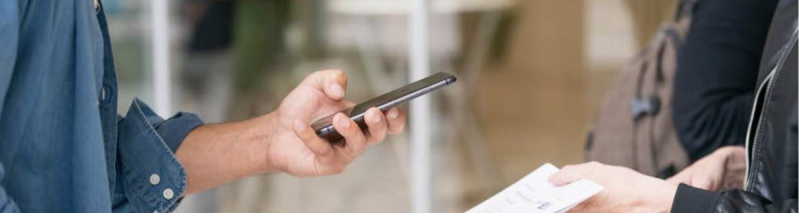 A person holding a phone to scan a code