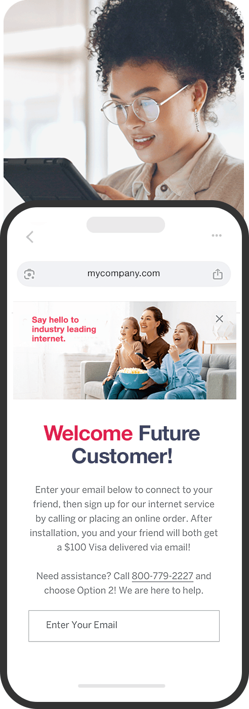 A customer looking at a referral on her phone while an employee helps nearby