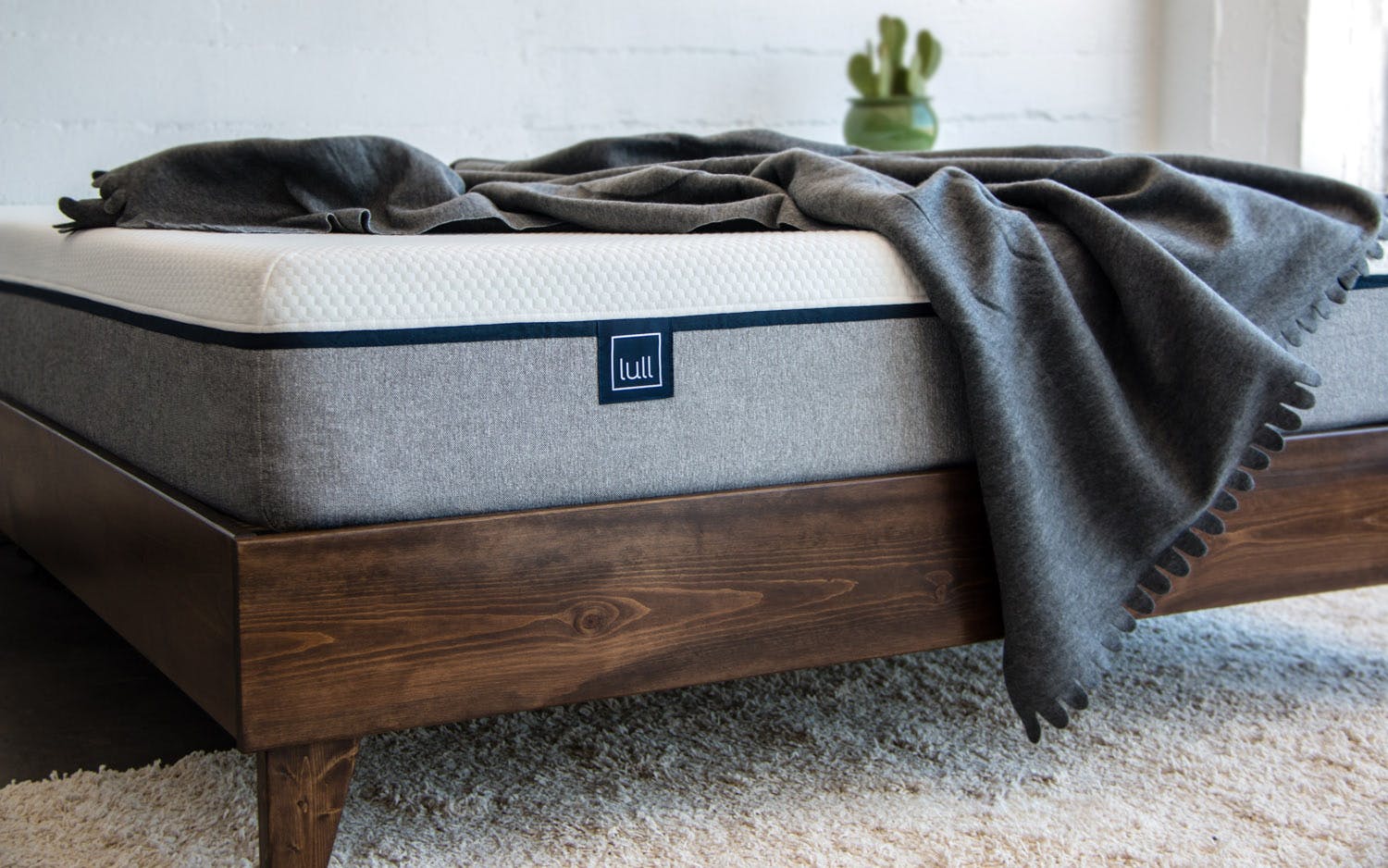 A Lull mattress on a wooden bed frame